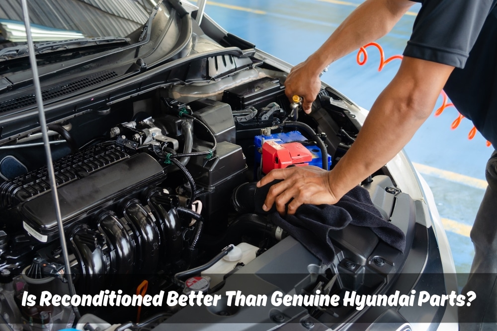 A mechanic repairs a car using Genuine Hyundai Parts.