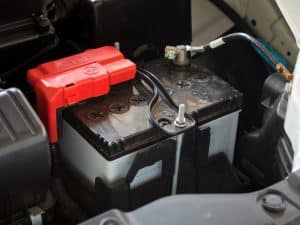 A car battery with corroded terminals. This could be a sign of a weak battery, causing the engine to run rough.