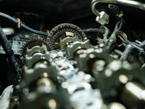 Close-up of a timing chain, highlighting the cost to rebuild engine and its crucial role in engine performance.